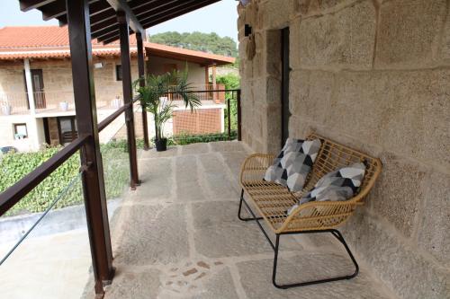 a wicker chair sitting on a patio at CASA VACACIONAL ACIO in Ourense