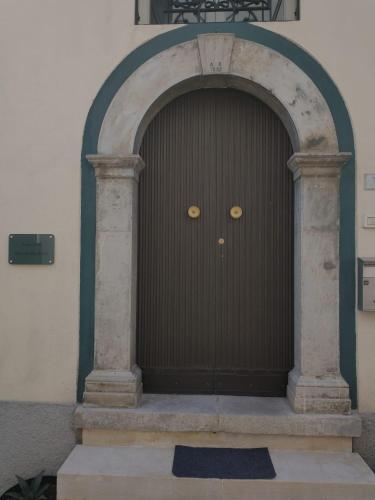 a large brown door in the middle of a building at Ruoti 1885 in Ruoti