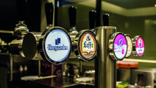 a row of four mirrors on a coffee machine at Amosa Liège City Centre Hotel in Liège