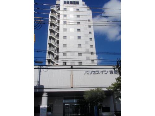 a tall white building in front of a building at Pulsesin in Kyoto - Vacation STAY 73552v in Kyoto
