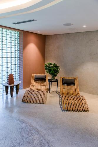 a room with two chairs and a table with a plant at Future Found Sanctuary, Luxury Boutique Hotel by NEWMARK in Cape Town