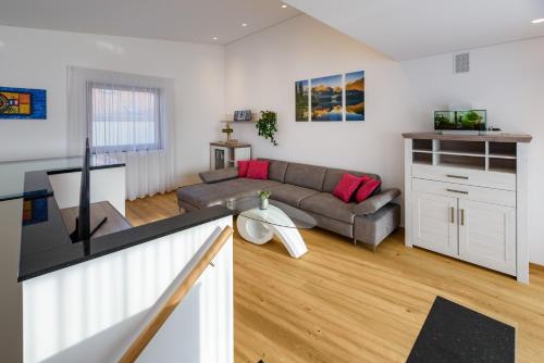 a living room with a couch and a tv at Gästesuite Jasmin in Laces