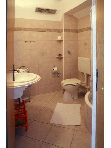 a bathroom with a toilet and a sink at Apartments Maletić in Kaštela
