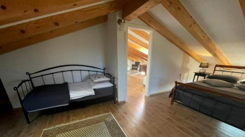 a bedroom with a bed and an attic at Stone House Rosuja in Ivanje