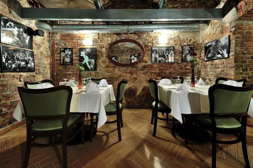 a dining room with white tables and chairs at Hotel Centrum Sosnowiec in Sosnowiec