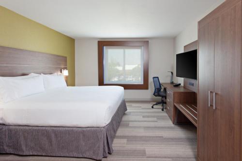 a hotel room with a bed and a television at Holiday Inn Express & Suites Pasadena - Los Angeles by IHG in Pasadena