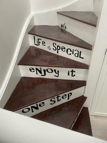 a staircase with a sign that says life is special enjoy it one step at 4 Torwood Gables. The Old Victorian School House in Torquay