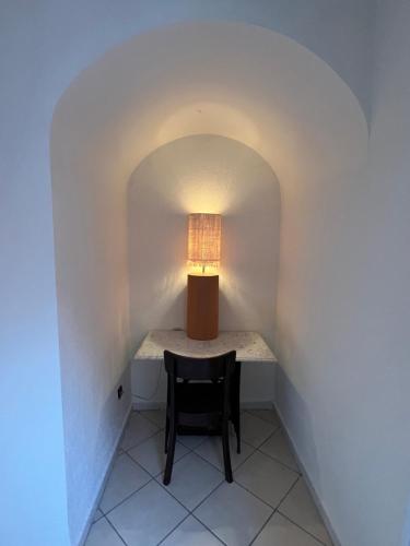 a lamp sitting on a table in a hallway with a chair at MORO Marrakech Boutique Hôtel in Marrakech