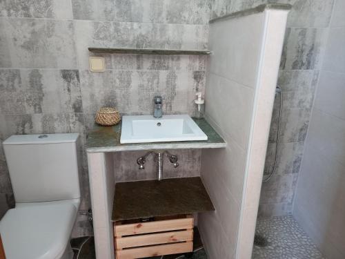 a bathroom with a sink and a toilet at Madilida Sifnos Apartment in Artemonas