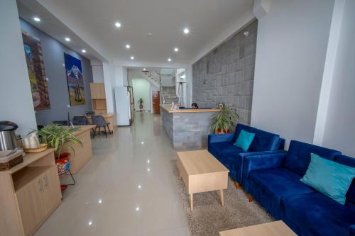 a living room with a blue couch and a table at Ayni Cusco Hotel in Cusco