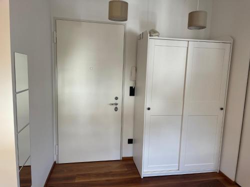a room with a white door and a closet at LaCasadiGuendy in Bolzano