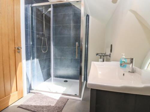 a bathroom with a shower and a sink at The Old Chapel in Hereford