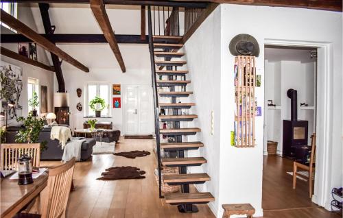 a spiral staircase in a room with a living room at 3 Bedroom Beautiful Home In Köpingebro in Köpingebro