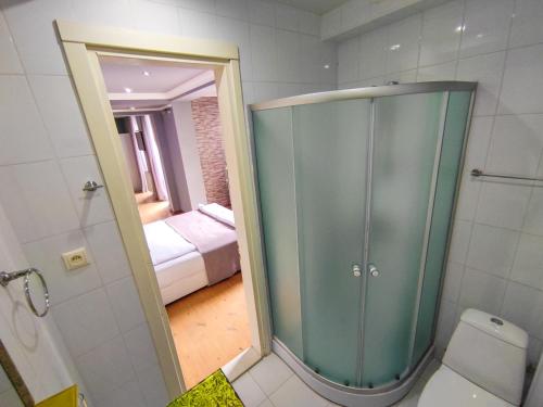 1 dormitorio y baño con ducha y aseo. en Aparthotel Old City, en Batumi