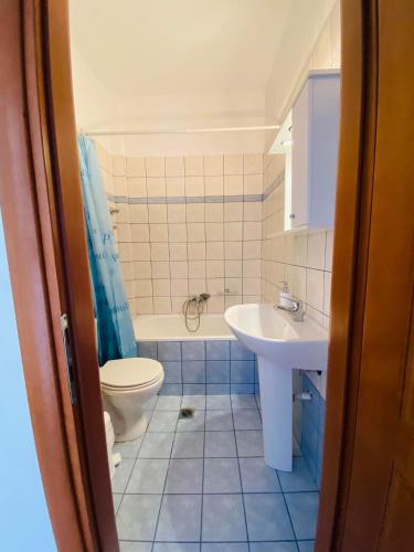 a bathroom with a toilet and a sink at Chrisa's Guest House in Skala Potamias