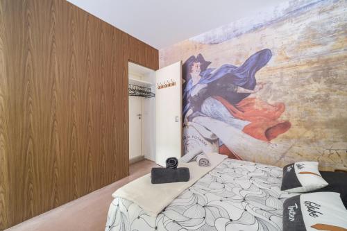 a bedroom with a bed and a mural on the wall at La Semeuse Hurst in Colmar