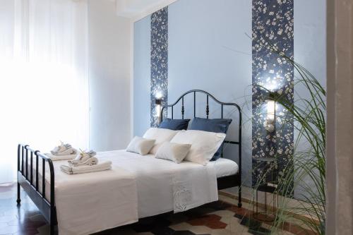 a bedroom with a bed with lights on it at Donna Elena - Epoque Residence in Asti