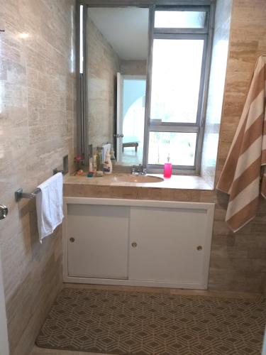a bathroom with a sink and a window at casa HIKURI in Cancún