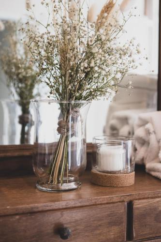 a vase with flowers in it on a table at Donna Elena - Epoque Residence in Asti