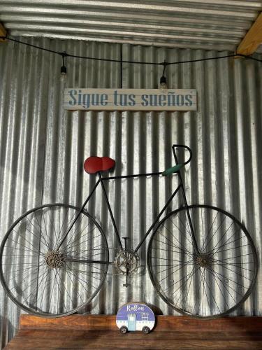 a bike on display in a garage with a sign at El Camper RV with pool. in Aguadilla