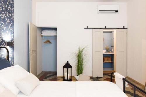 a bedroom with a bed and a sliding door at Donna Elena - Epoque Residence in Asti