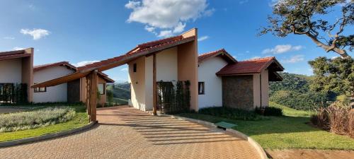 a house with a pathway leading to the front yard at Lavandas de Cunha Pousada Boutique in Cunha