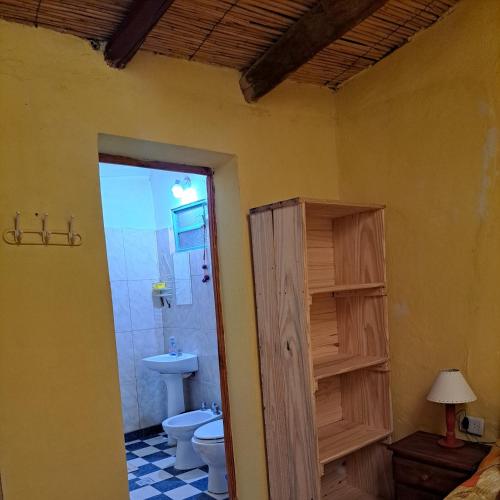 a bathroom with a toilet and a sink at Hostería el Sol Naciente in Tilcara