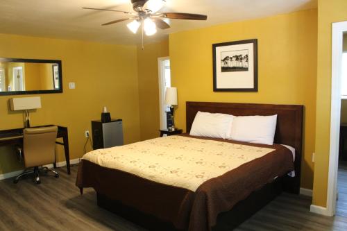 A bed or beds in a room at Carmel Wayfarer Inn