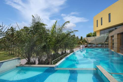a large blue swimming pool next to a building at Radisson Salem in Salem