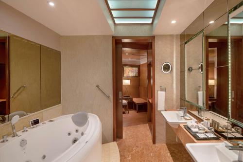 a large bathroom with a tub and two sinks at Radisson Salem in Salem