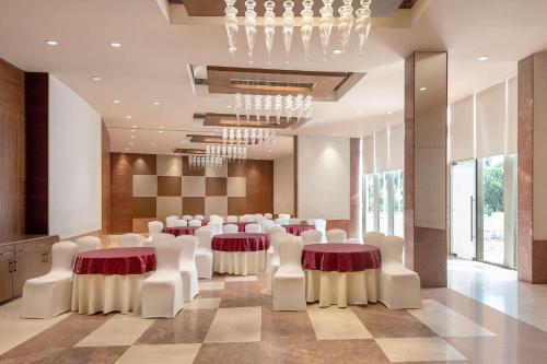 a conference room with white chairs and tables and a chandelier at Radisson Salem in Salem