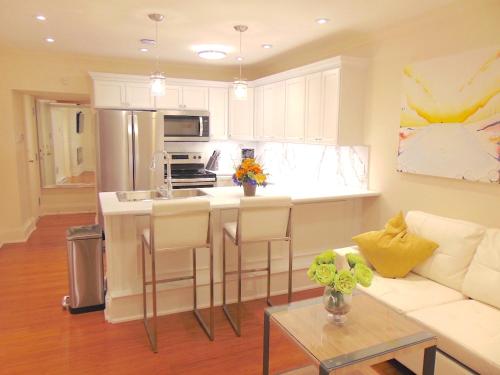 a kitchen and living room with a couch and a table at Water Street Condos in St. John's