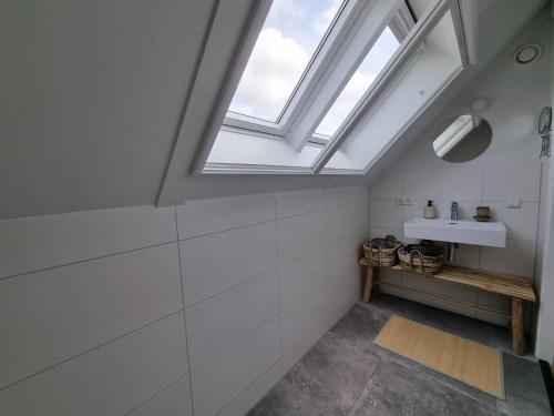 a bathroom with a sink and a skylight at Villa in Balk with Private Jetty on Slotermeer in Balk