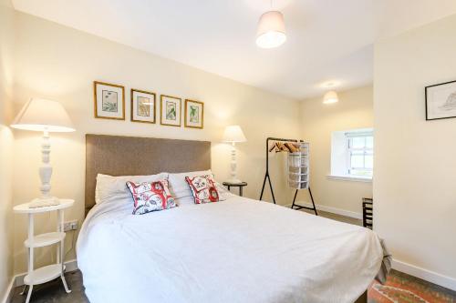 A bed or beds in a room at The Garden Cottage