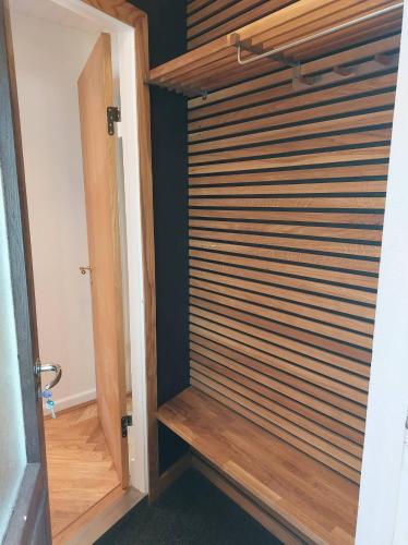 a room with a wooden door with wooden blinds at Tórshavn City Apartment in Tórshavn