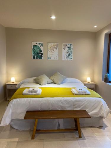 a bedroom with a large bed with two towels on it at ANTAKARANA in Lozano