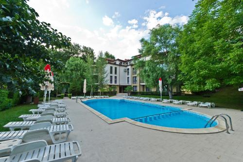 a swimming pool with lounge chairs and a building at Family Hotel Edia-Sandanski in Sandanski