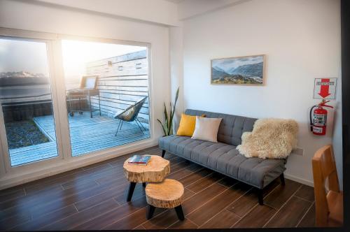 a living room with a couch and a table at Turek Bahía Suites in Ushuaia