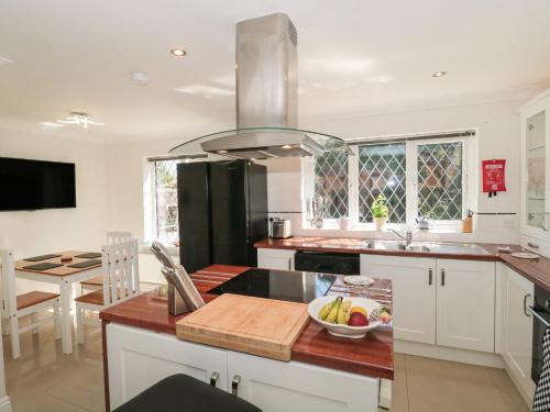 a kitchen with a counter top with a bowl of fruit at 1 Charlotte Close in Bournemouth