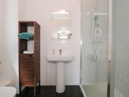 a bathroom with a sink and a shower at 1 Charlotte Close in Bournemouth