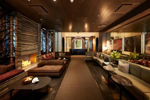 a large living room with couches and tables at Loden Vancouver in Vancouver