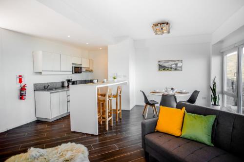 a living room and kitchen with a couch and a table at Turek Residences in Ushuaia