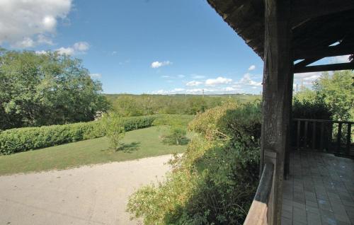 a porch of a house with a view of a garden at Rivier in Flaujac-Poujols