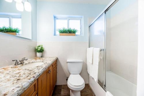 a bathroom with a toilet and a sink and a shower at Steps to Sand and Sea 4 in Fort Lauderdale