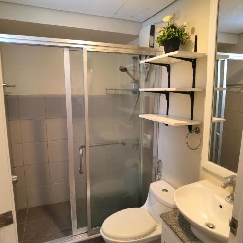 a bathroom with a shower and a toilet and a sink at Avida Davao Condos, downtown CM Recto Avenue, Davao City in Davao City