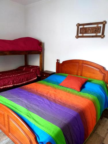 a rainbow colored bed in a room with at Las Calandrias in Villa Constitución