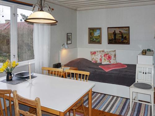 a room with a bed and a table and chairs at 6 person holiday home in 38472-By Traum in Tillingenabben