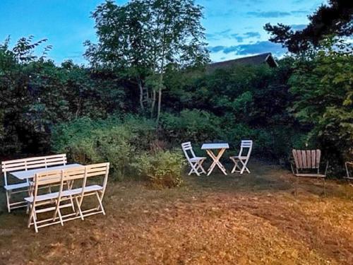three chairs and a table in a yard at 6 person holiday home in 38472-By Traum in Tillingenabben