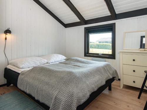 een slaapkamer met een bed en een raam erin bij Holiday home Hejls LV in Hejls