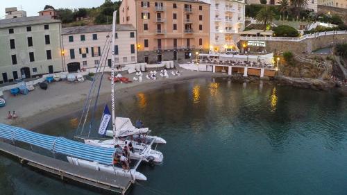 a sail boat docked at a dock in the water at Hotel Helvetia in Sestri Levante